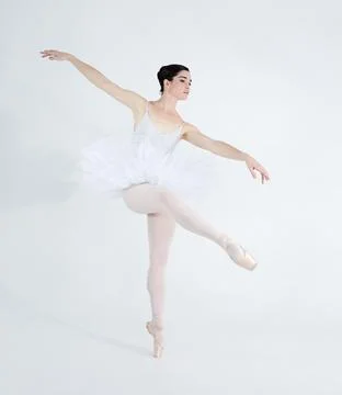 Each step expresses her love for dance. Elegant young ballerina dancing en Stock Photos