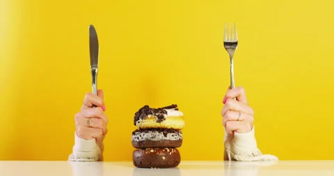Eager Hands with Utensils Facing Donut Stack 動画素材 310937540