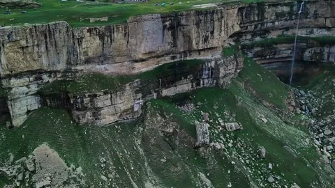 The eagle flies over a mountain gorge and waterfalls Stock Footage 143230390