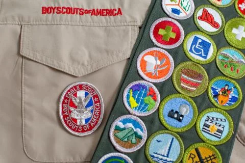 Eagle patch and merit badge sash on boy scout uniform Stock Photos