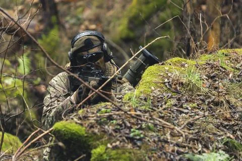 Eagle like precise aim rifle camouflaged in the woods Stock Photos