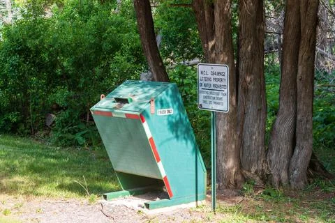 Eagle River, MI - June 22, 2022: Animal proof trash receptacle in public park Stock Photos