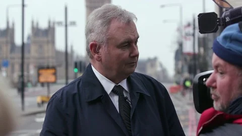 EAMONN HOLMES WAITS TO DO A WESTMINSTER LONDON Stock Footage 80488280