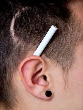 Ear with cigarette Stock Photos