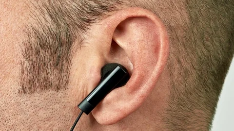 Ear with earphone vibrating and jumping to music Stock Footage 72321533