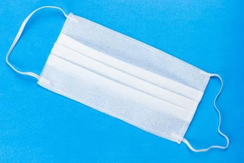 Ear-loop face mask on blue background. dust protection respirator and breathi Stock Photos
