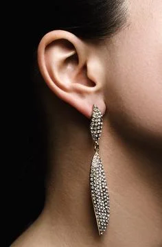 Ear with silver earring Stock Photos
