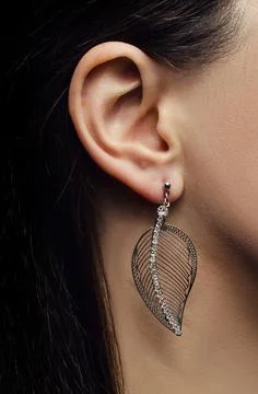 Ear with silver earring Stock Photos