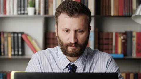 Earache. Close-up of upset man at workplace, he touches his ear with finger Stock-Footage 132705623