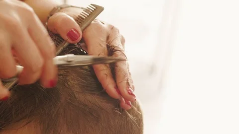 Earlock between fingers, barber cutting hair by scissors Stock Footage 115598220