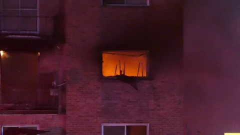 Early arrival at apartment bloc fire Stock Footage 104234703