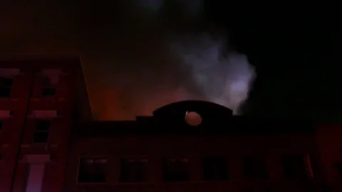 Early arrival at structure fire with police cars and firetruck Stock Footage 116083572