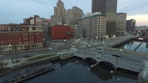Early morning city landscape aerial climb with buildings and street with canal Stock Footage