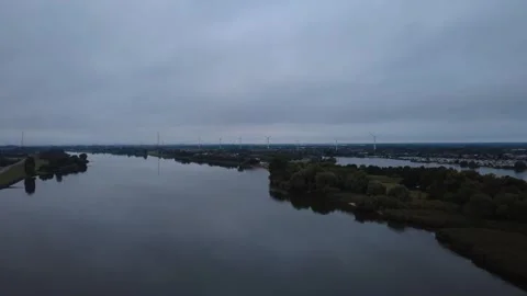 Early Morning Drone Flight Over Wide River with Calm Water Stock Footage 328538555