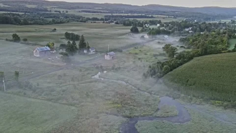 Early in the morning, drones fly over farmhouses, fields and pastures. Stock Footage 170938959