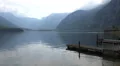 Early morning Hallstatt mountain lake panning alps HD Footage