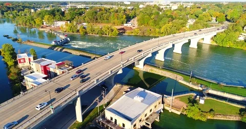 Early morning rush hour traffic on bustling city bridge Stock Footage