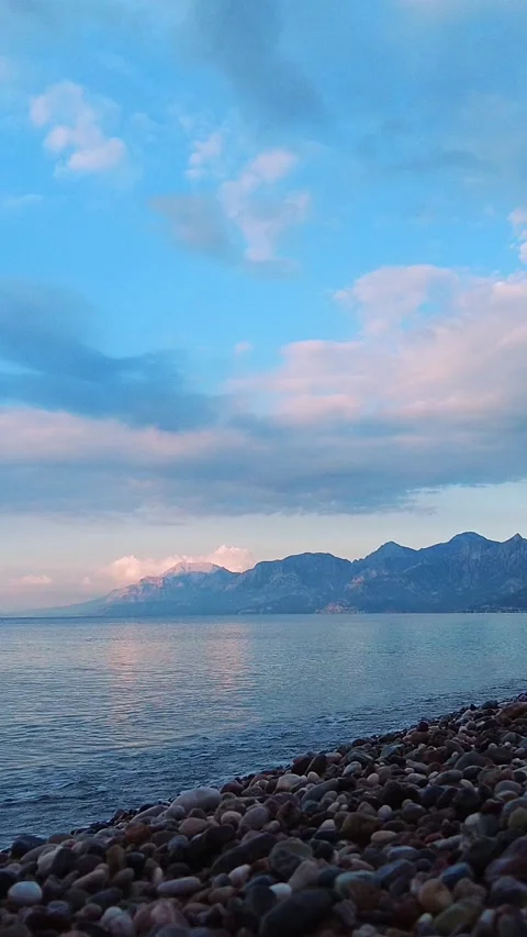 The early morning on the seaside with soft clouds and gentle water movement Video stock 323249448