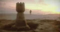 Early morning sunrise on beach with sandcastle and Jogger. HD Footage