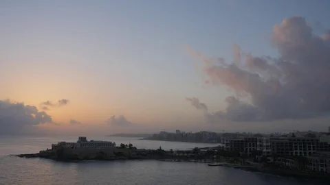Early morning timelapse of clouds o a beautiful morning at Dragonara Point Malta Stock Footage