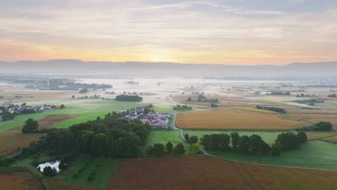 Early morning view over field and village at sun rise in early autumn Stock Footage 252077832