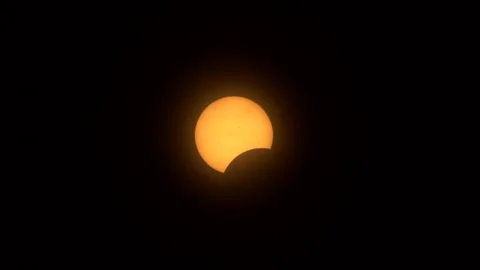 Early phase of a total solar eclipse with the moon partially obscuring the Video stock 272406045