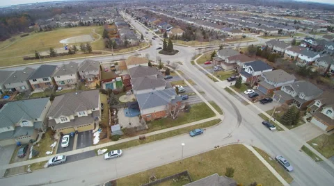 Early Spring flight over a Residential area near a Traffic Circle Stock Footage 61366896