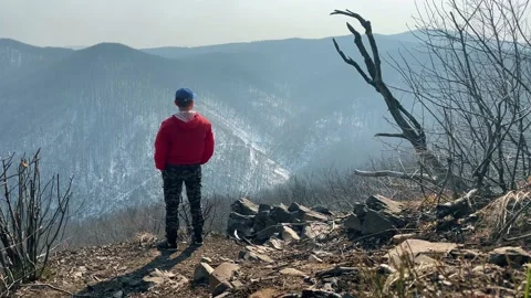 Early spring forest. Mount view. A man enjoys watching mountains view. Stockbeeldmateriaal 151649544