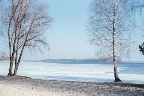 Early spring ice covered river bank landscape Stock Photos