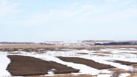 Early spring. Landscape of early spring, snow begins to melt, fields open. Stock Photos