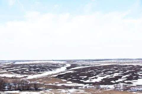 Early spring. Landscape of early spring, snow begins to melt, fields open. Stock Photos