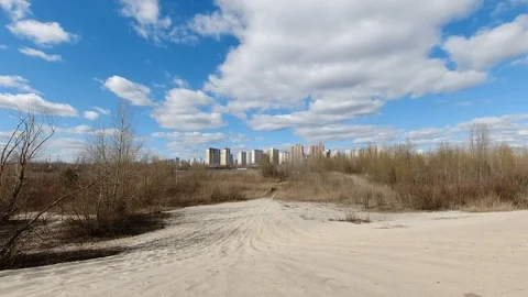 Early spring landscape of sand desert with city view on the horizon and fast Stock Footage 126508942