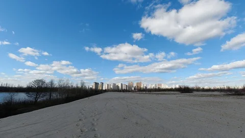 Early spring landscape of sand desert with city view on the horizon and fast Stock Footage 127746149