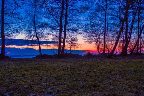 Early Spring Landscape with Sunset over Lake Stock Photos