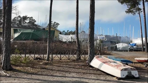 Early spring marina scene in Nynäshamn, Sweden, featuring covered boats. Stock Footage 333590404