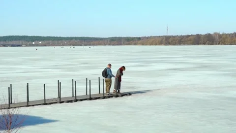 As the early spring sun begins to warm the landscape, two individuals tread care Stock Footage 343709083