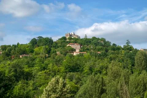 Early summer view across fields to hilltop Penne d'Agenais. Stock Photos