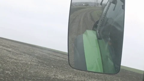 Early winter field view from moving modern tractor in rear-view mirror Stock Footage 70082096