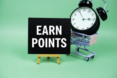 Earn Points text message on paper card with alarm clcok and trolley shoppin.. Stock Photos