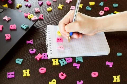 Earning English is an online program for learning English. Little boy writes Stock Photos