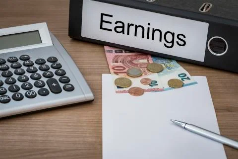 Earnings written on a binder Stock Photos