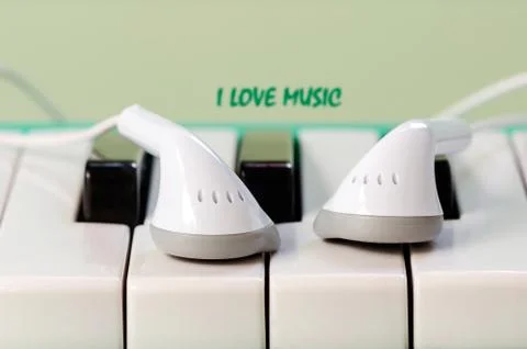 Earphone on the keyboard Stock Photos