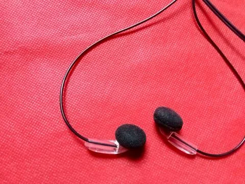 Earphone on red background  Фото