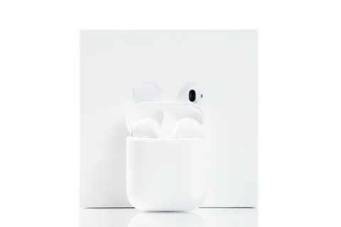Earphones and box. Wireless technologies. Stock Photos