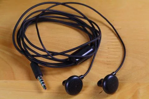 Earphones with the wire winded on itself Stock Photos