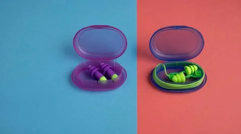 Earplugs in a container on a colored background Stock Photos