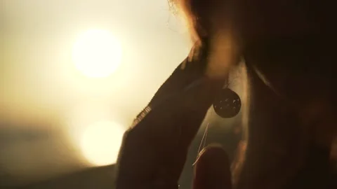 Earring close-up at sunset Stock Footage 138252562