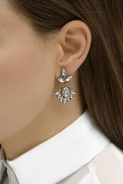 Earring on the woman's ear Stock Photos
