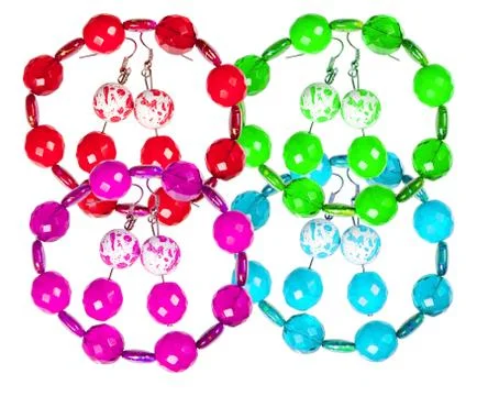 Earrings and bracelets made of plastic and glass on a white background. colla Stock Photos