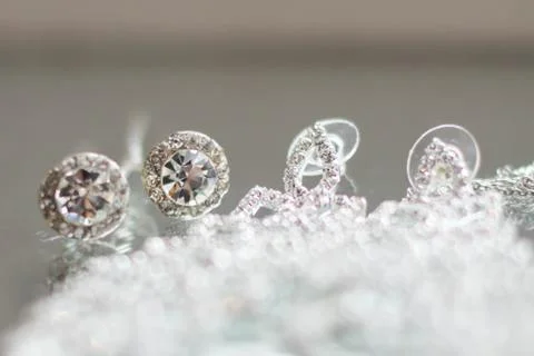 Earrings in the blurred background with reflection closeup Stock Photos